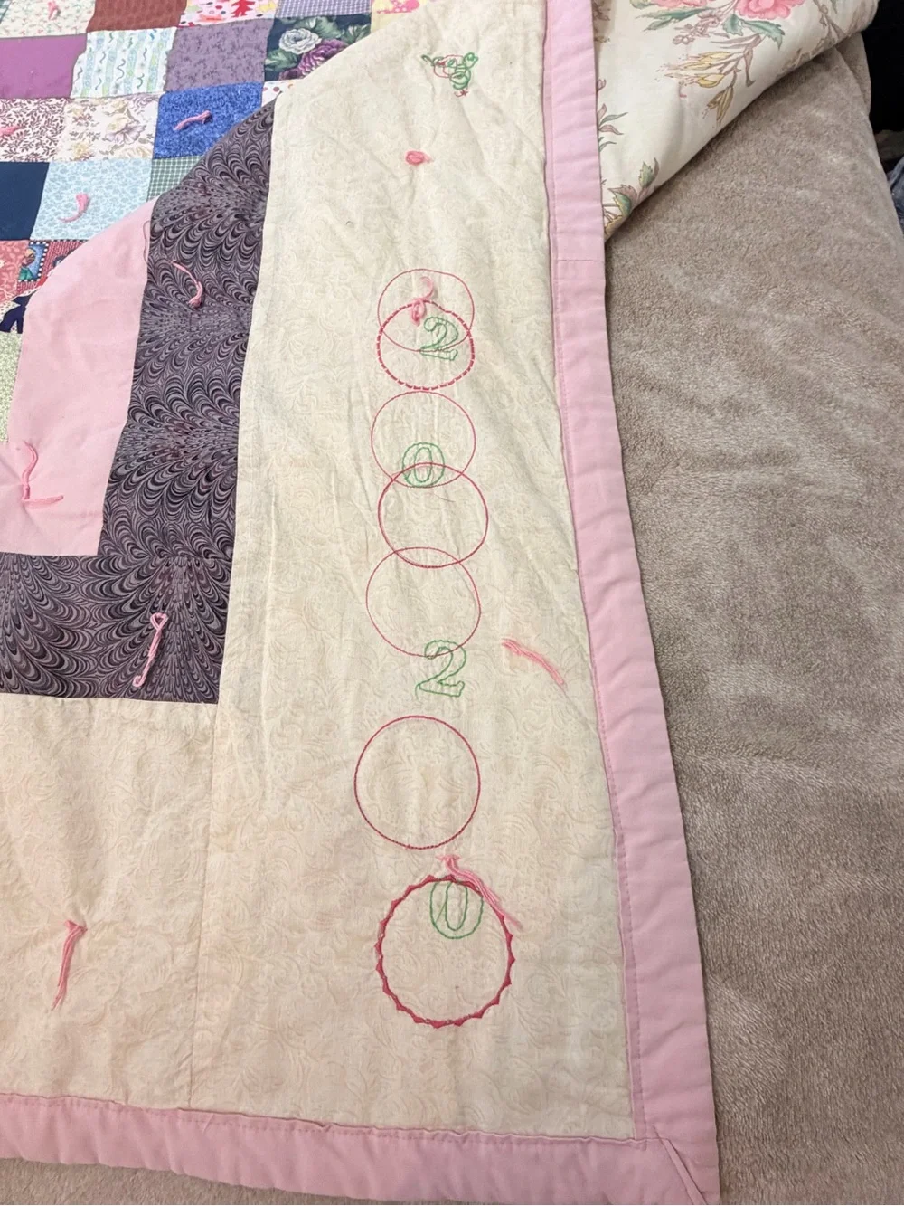 Hand crafted patchwork quilt with tan border